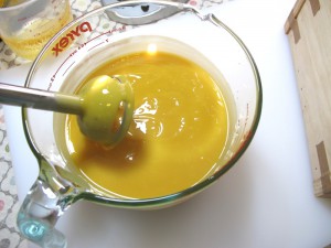 Stick blending the soap batter.
