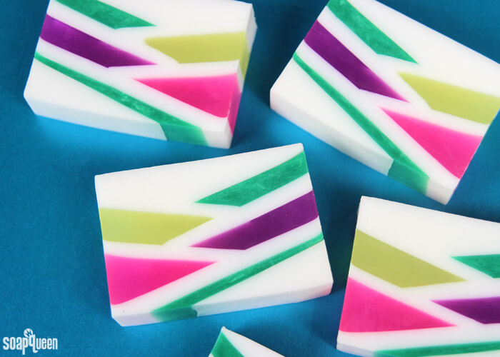 This Neon Geometric Melt and Pour Soap uses bright colors and layers to create a fun retro inspired design. Learn how to make it in this step by step tutorial!