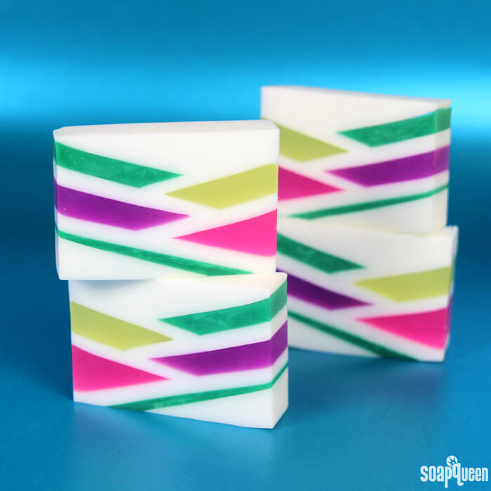 This Neon Geometric Melt and Pour Soap uses bright colors and layers to create a fun retro inspired design. Learn how to make it in this step by step tutorial!