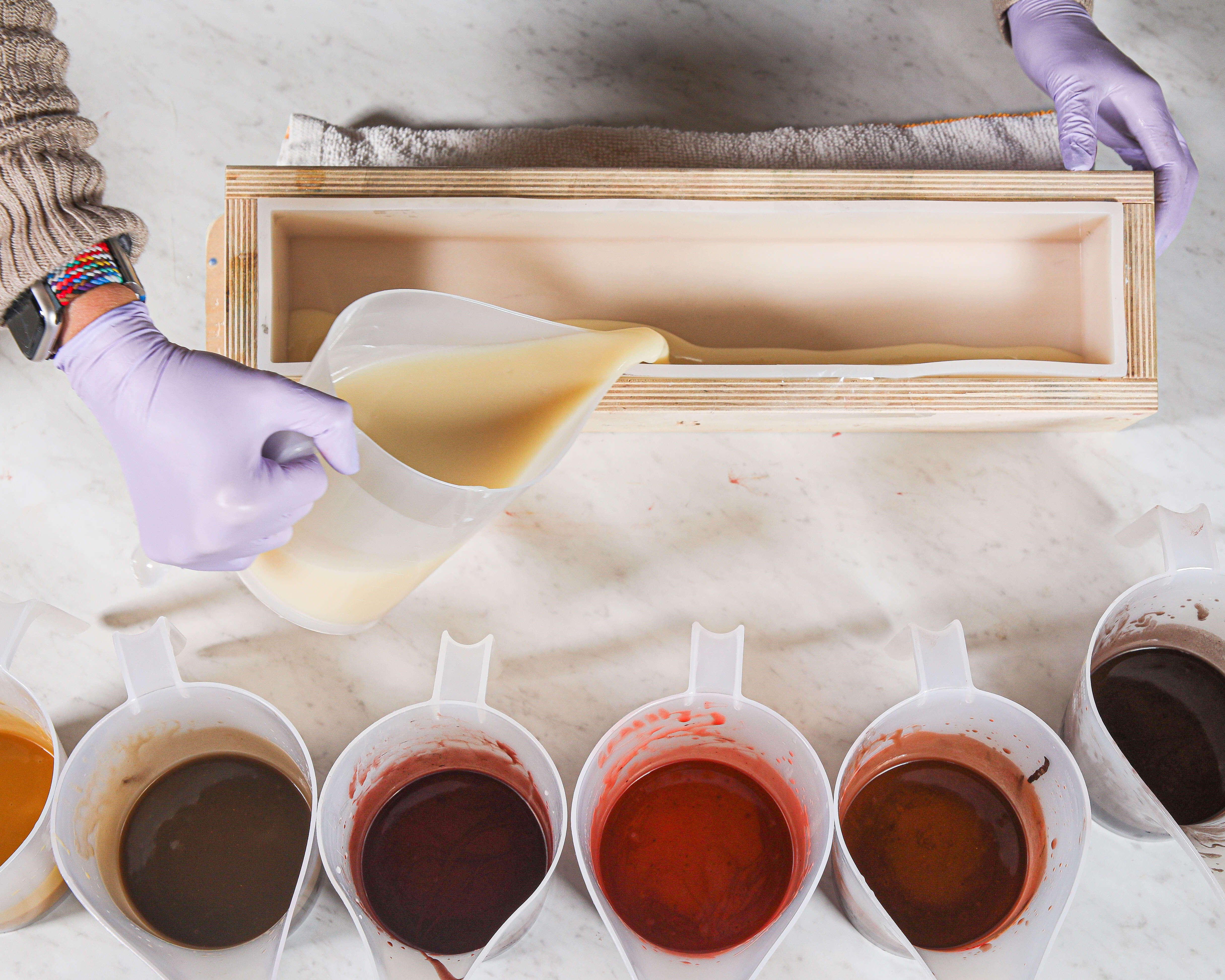 Colored soap batter Fall-colored soaps split into containers and ready to pour