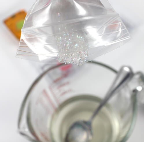 Pouring glitter into the soap.