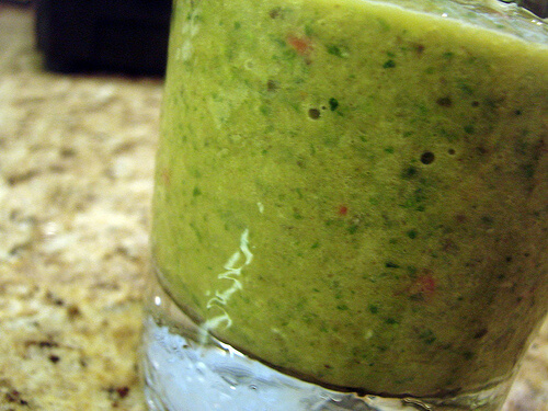 Green smoothie made with vegetables and spinach.