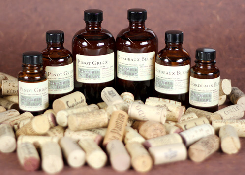 Wine fragrances oils surrounded by corks.