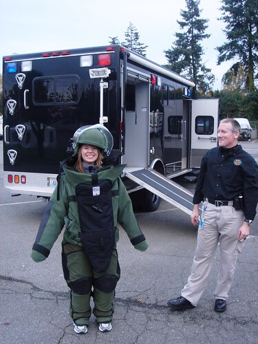 Anne-Marie in a bomb squad kevlar suit