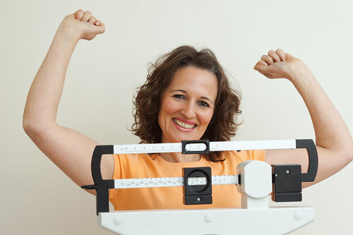 Happy woman on a scale