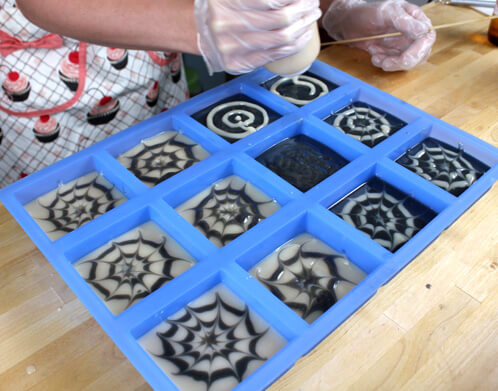 Spider web cold process soap in the 12 bar silicone mold.