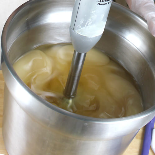 Blending cold process soap with a stick blender.