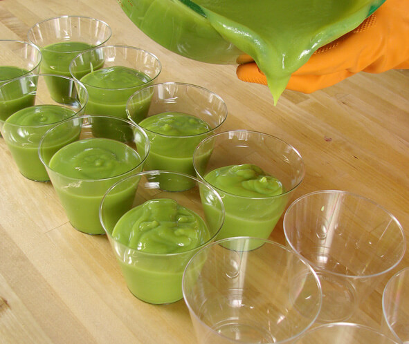 Pouring beer soap into cups for molds