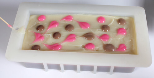 Dragging a skewer through the dots to make hearts.