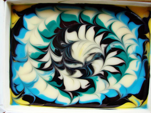 Yellow, blue, white and black swirled soap.