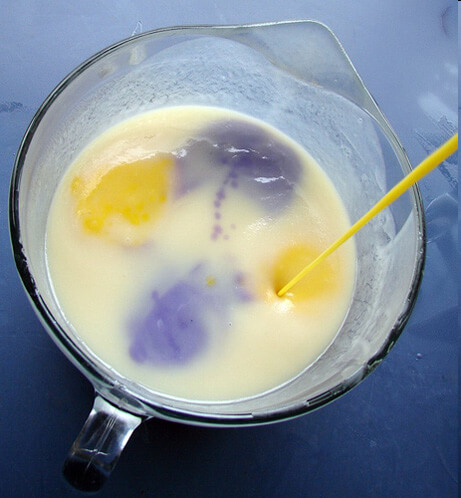 Yellow being poured into the white soap for In The Pot Swirl.