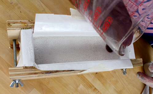 Carefully pouring the second layer of soap.