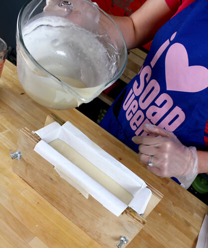 Pouring the first layer of soap into the mold.