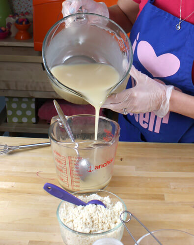Anne-Marie separating out her batch of soap for coloring.