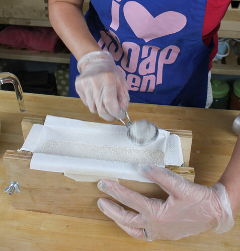 Sprinkling a vein of mica on the first layer of soap.
