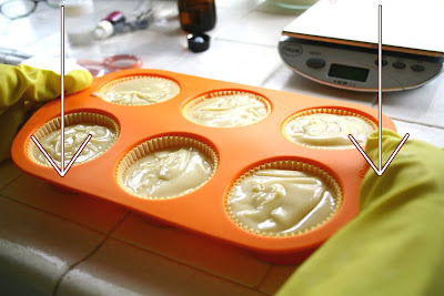 Tapping the mold so no bubbles remain in cold process soap