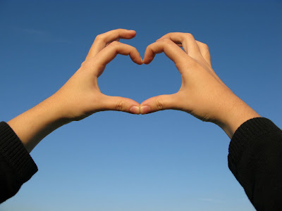 Making a heart with fingers